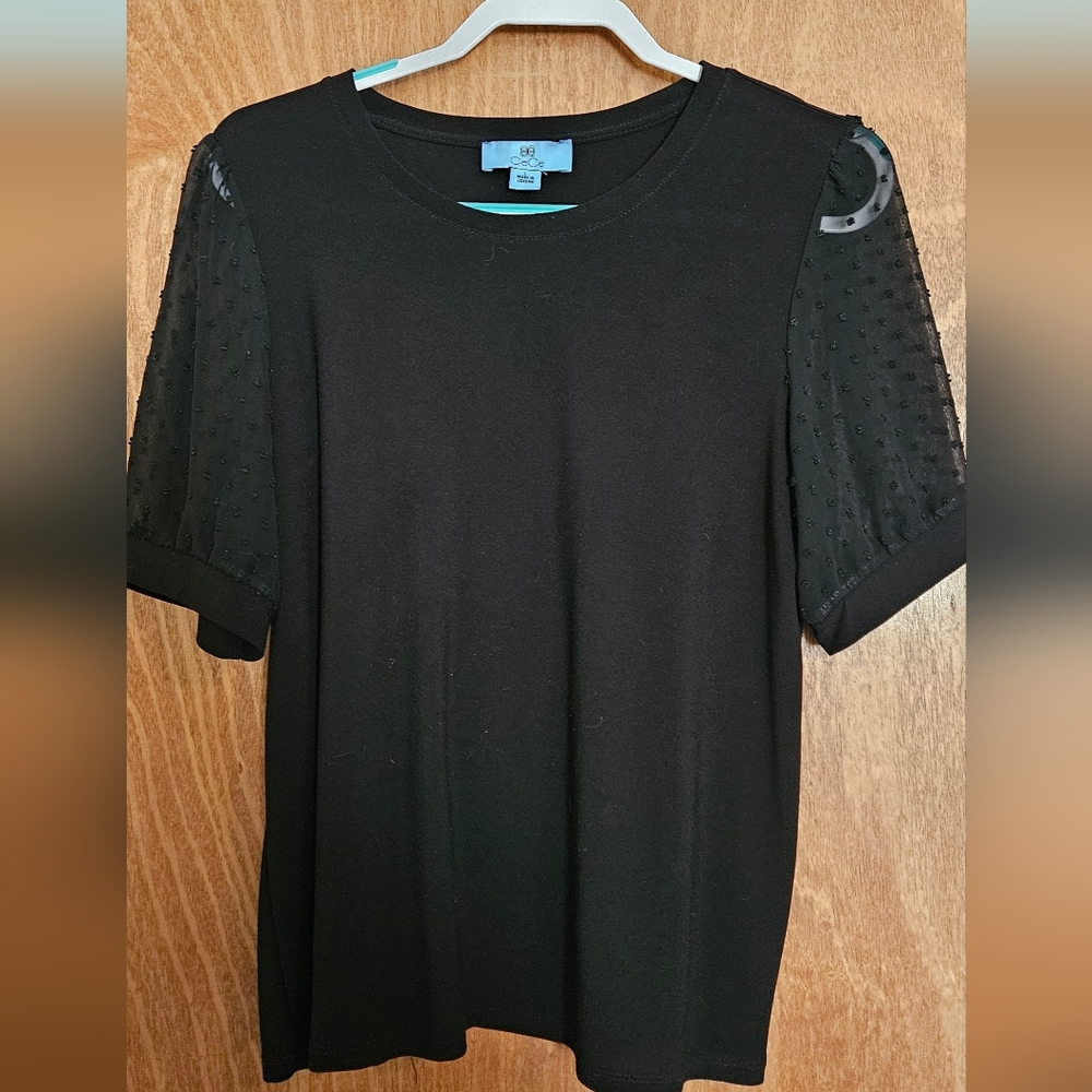 Black casual work shirt with sheer polka dot sleeves. Size large